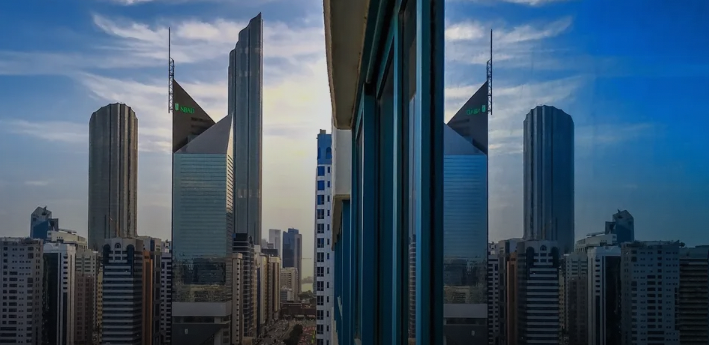 Skyline view of Al Danah district in Abu Dhabi with high-rise buildings, covered by our car towing service